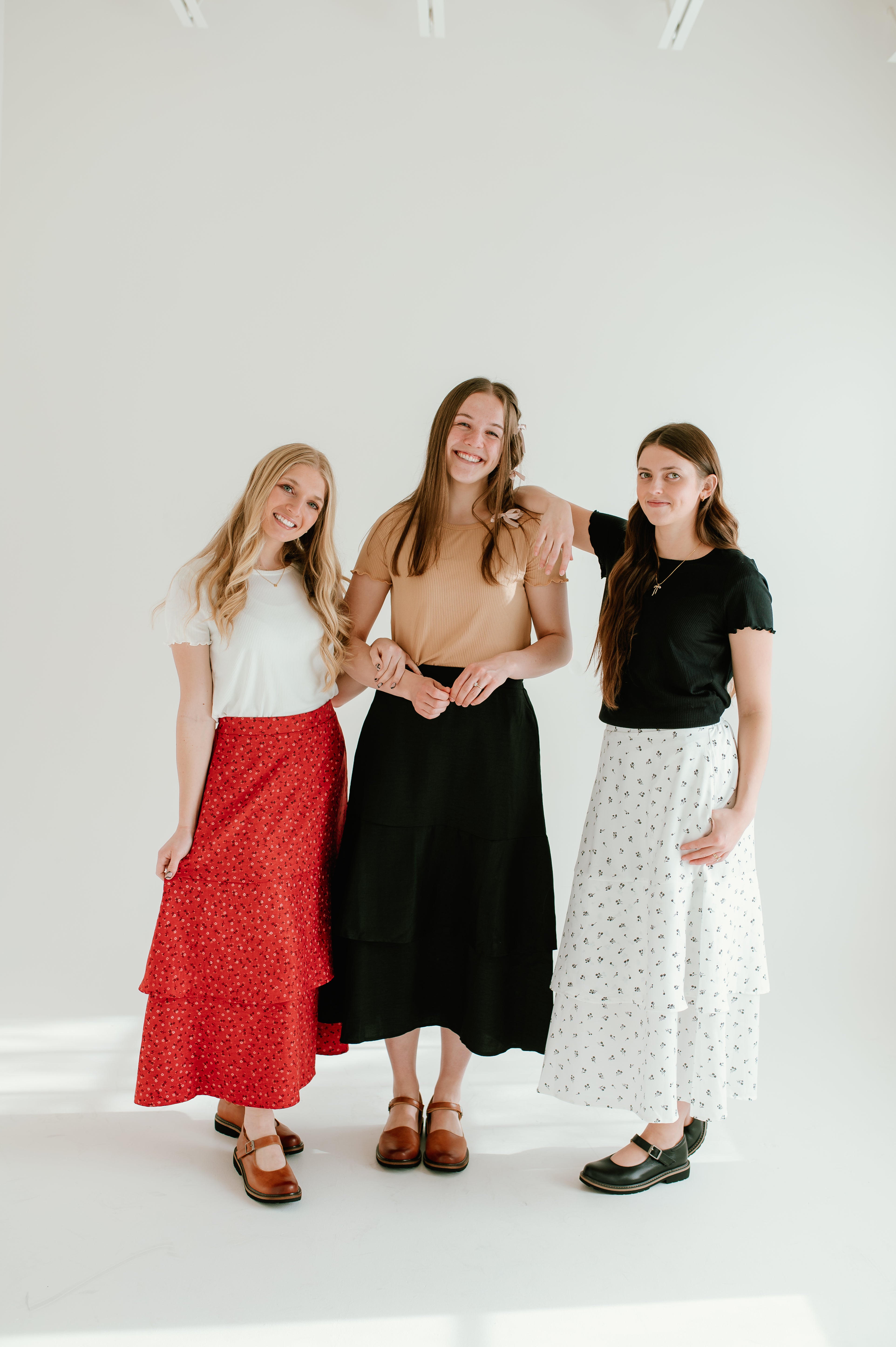 red floral, black, and white floral tiered midi skirts