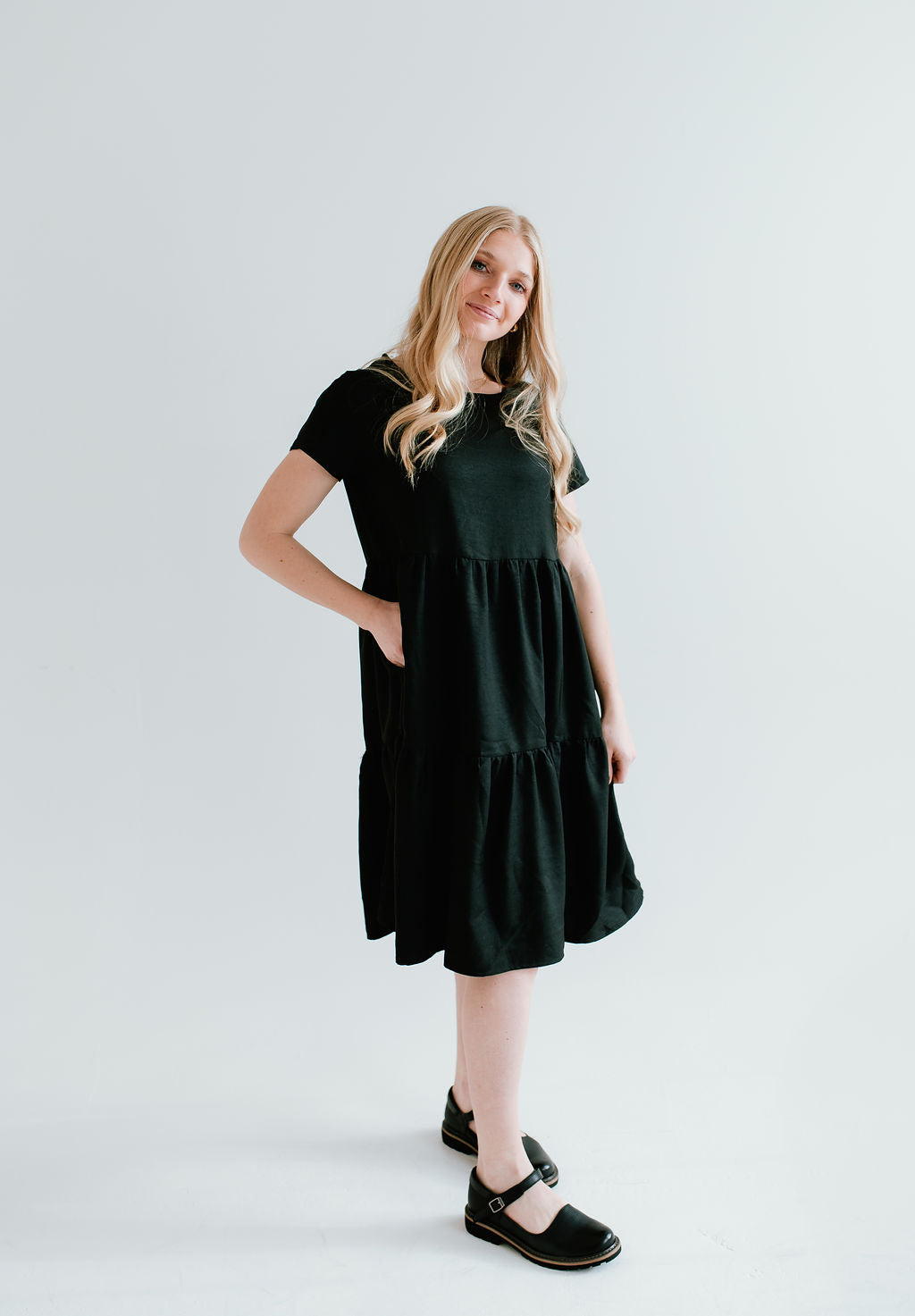 Black modest midi (right below the knee) dress with pockets.