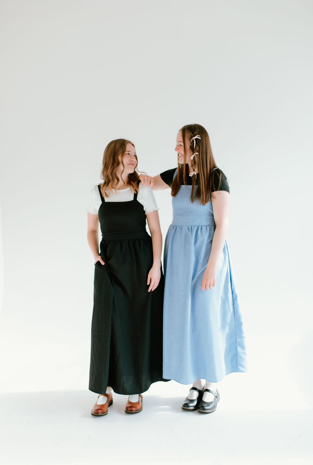  black and blue inch wide strap jumper with ankle length and form fitting bodice.