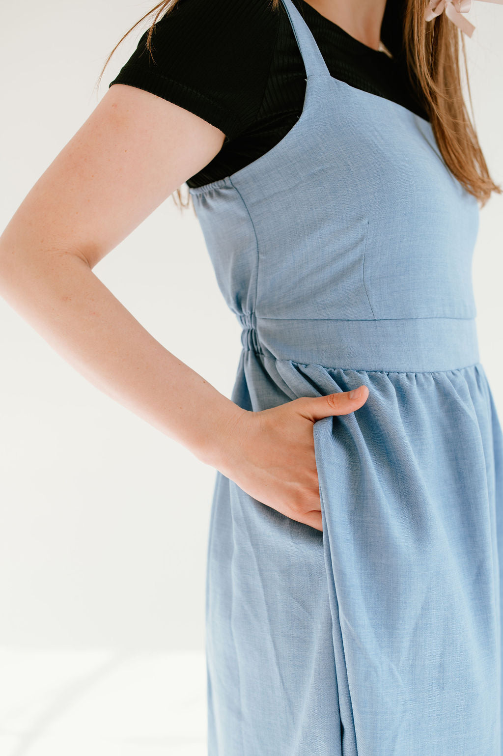  blue inch wide strap jumper with ankle length and form fitting bodice.