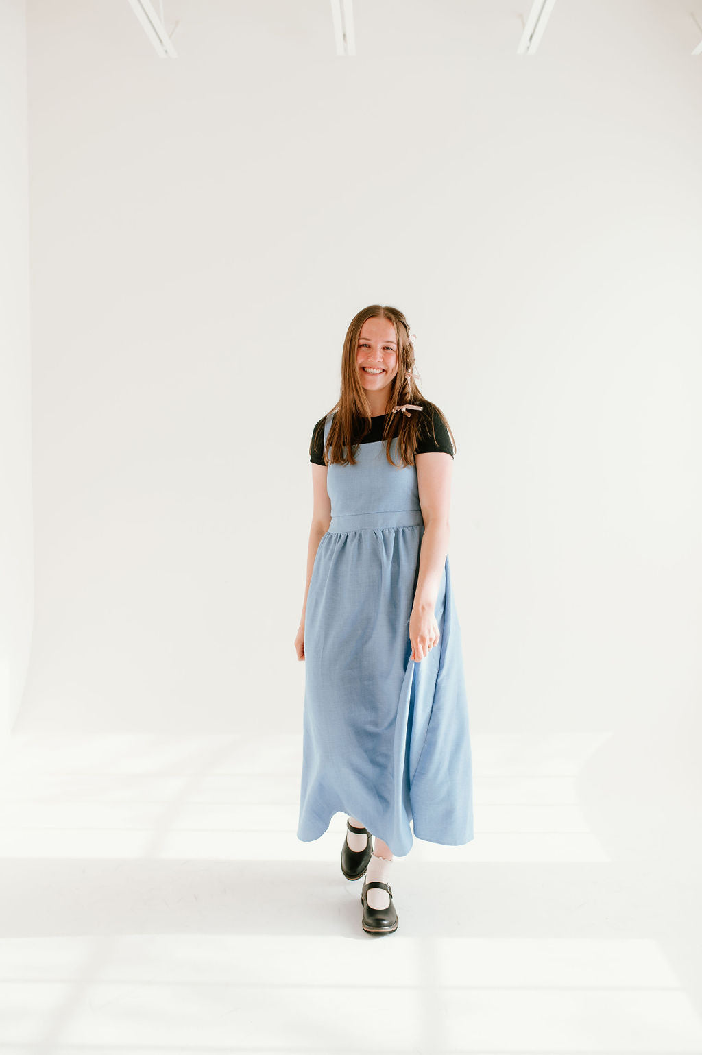  blue inch wide strap jumper with ankle length and form fitting bodice.
