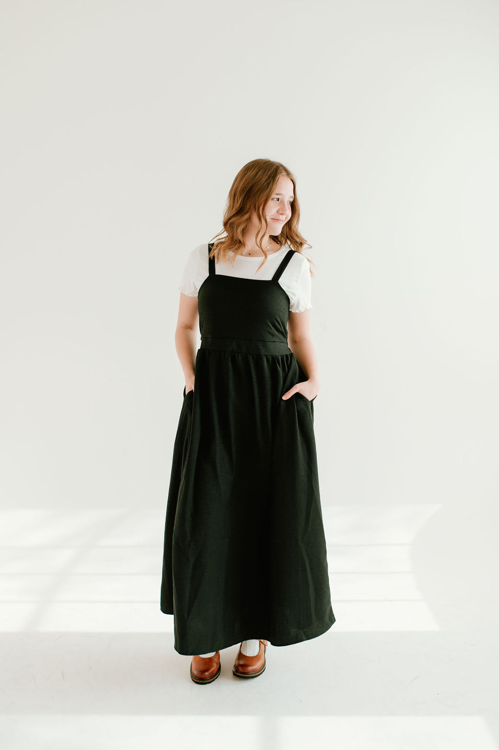  black inch wide strap jumper with ankle length and form fitting bodice.
