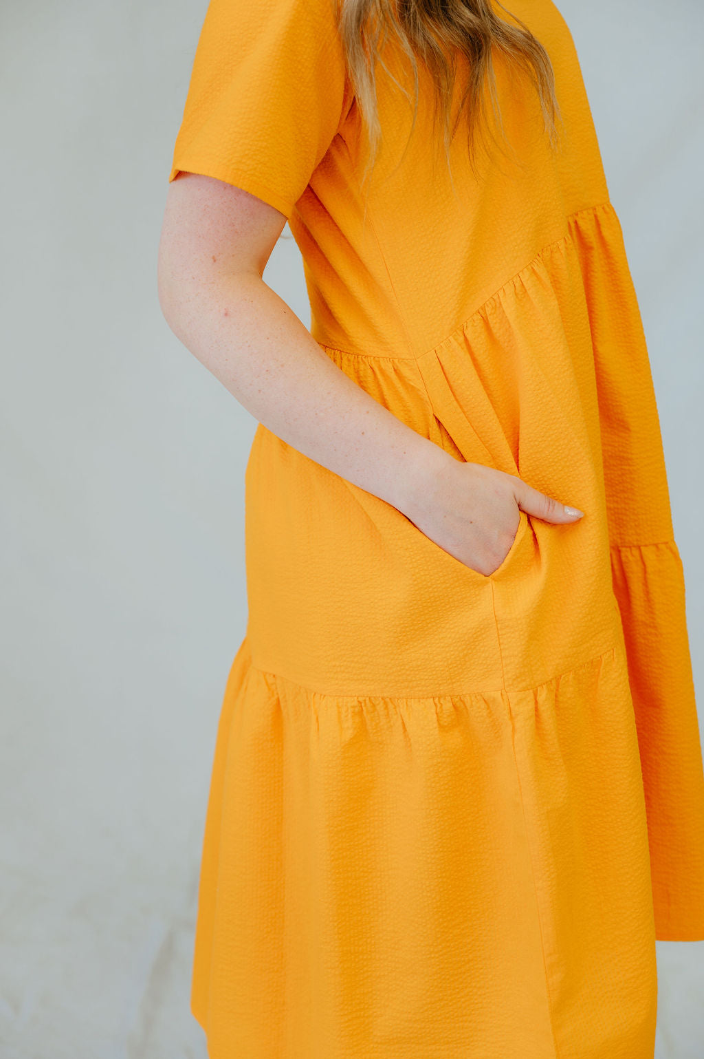 This dress features a tiered skirt, flowy sleeves, and pockets! 