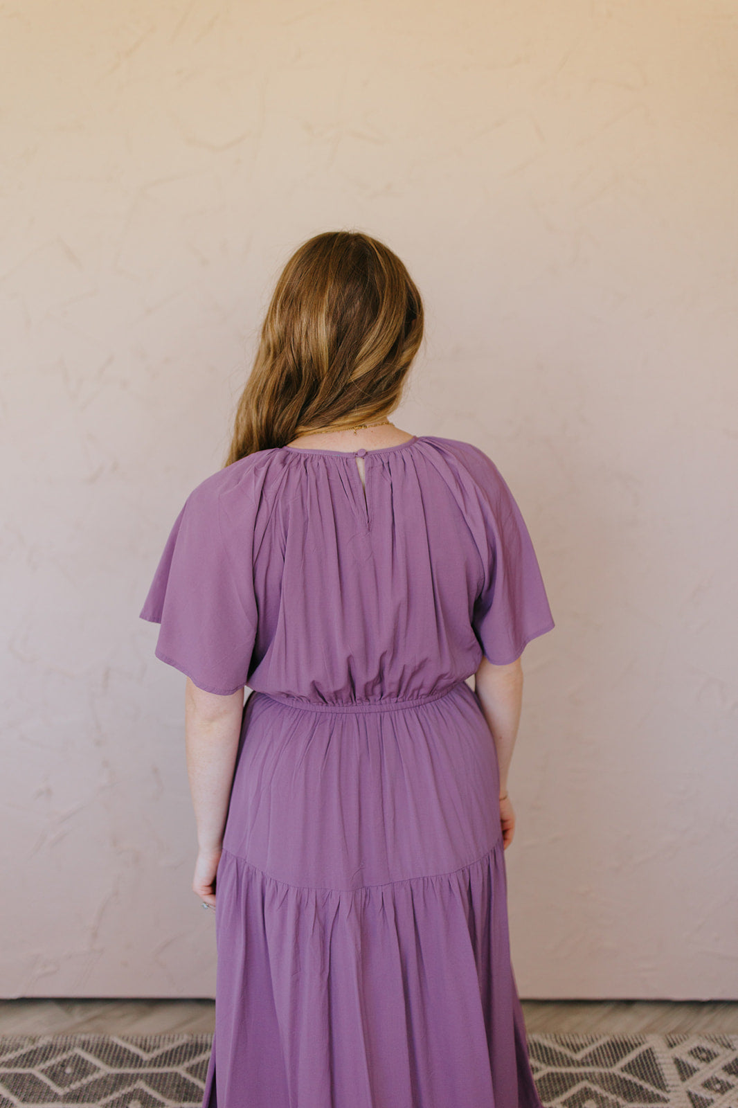woman wearing a purple dress