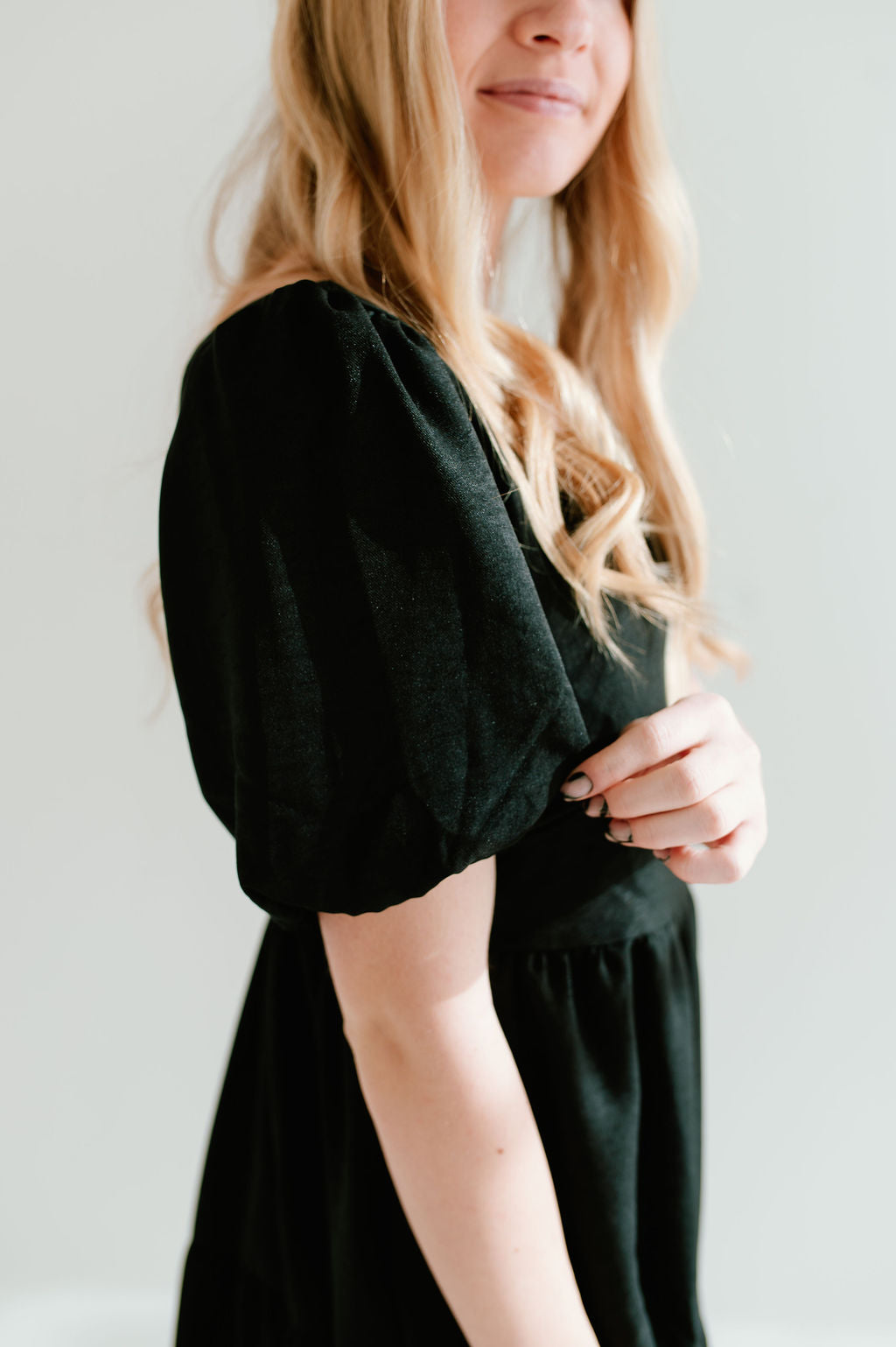 Modest black dress with short sleeves and pockets.