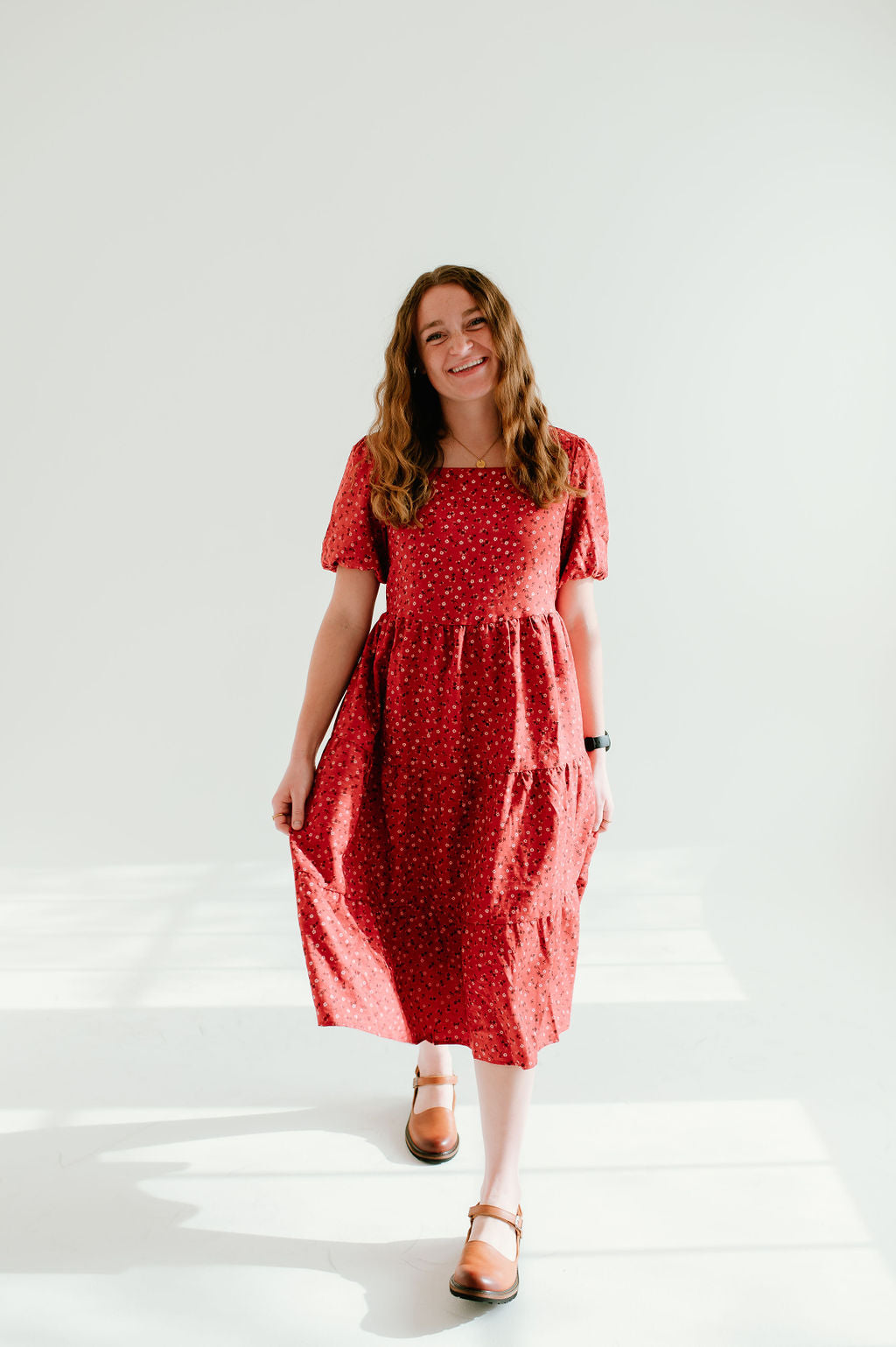Modest red floral dress with short sleeves and pockets.