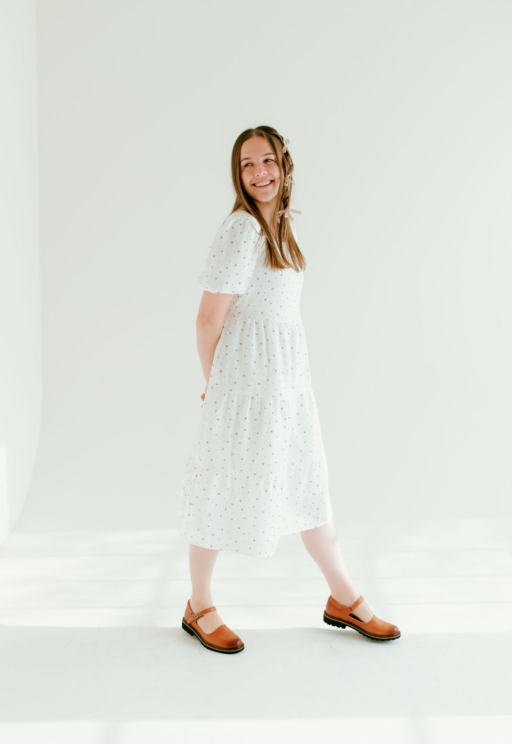 White floral dress with short sleeves and pockets.