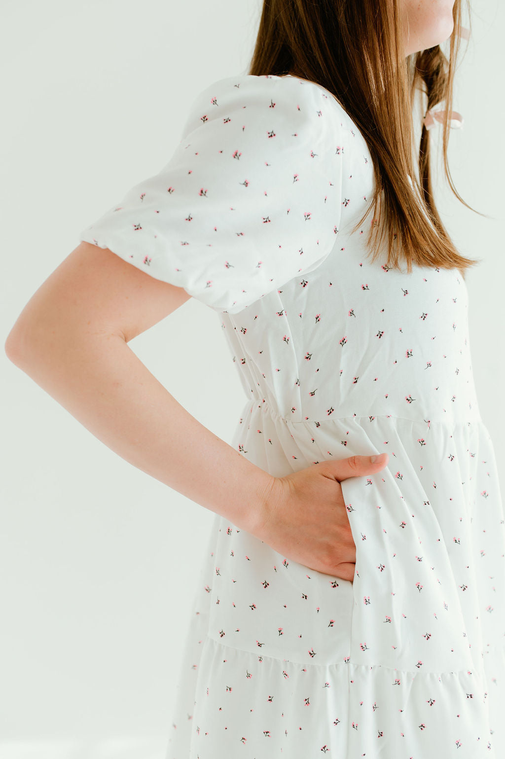 White floral dress with short sleeves and pockets.