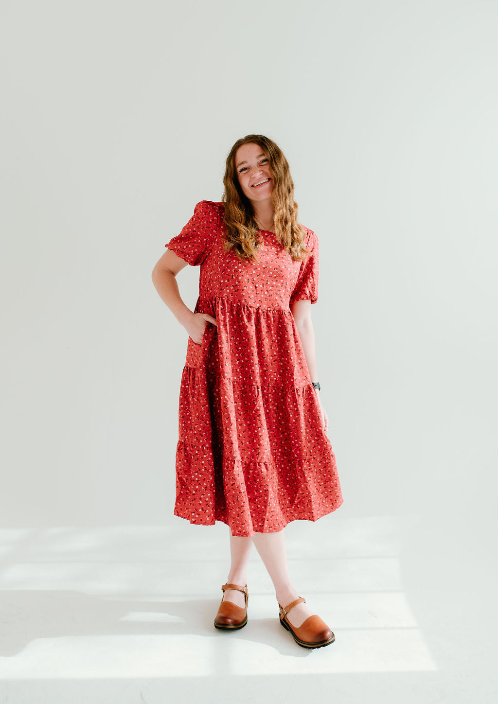 Modest red floral dress with short sleeves and pockets.
