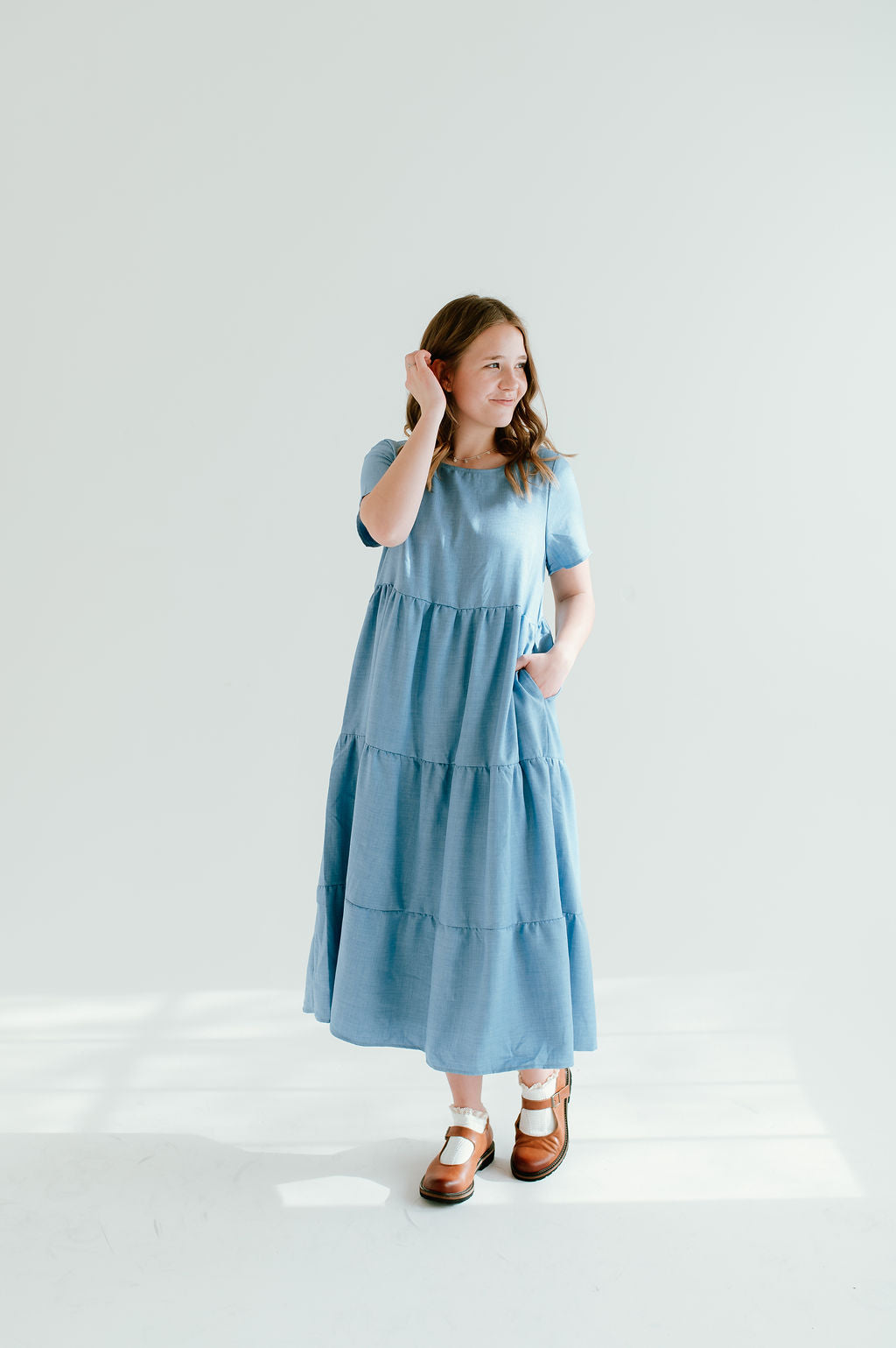 Modest sky blue dress with short sleeves and pockets.