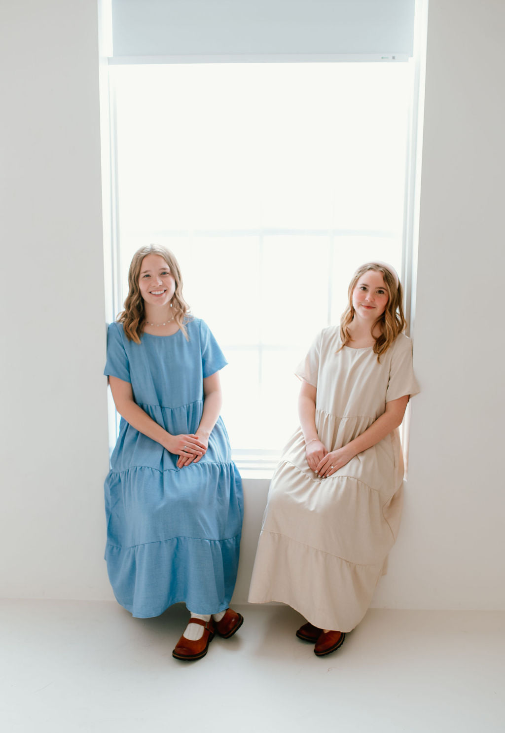 Modest sky blue dress and tan dress with short sleeves and pockets.