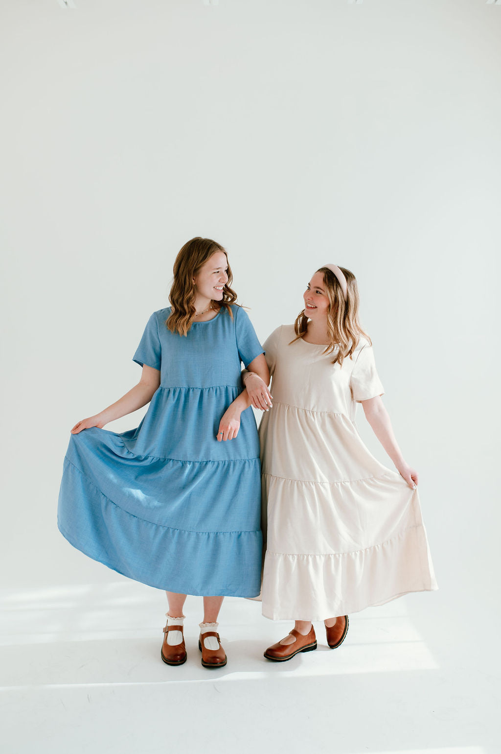 Sky blue and tan dresses with short sleeves and pockets.